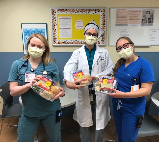 Three Members Posing With Meals