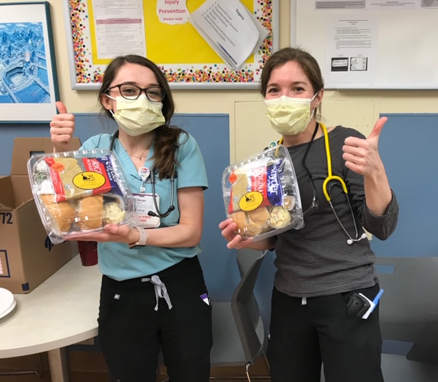 Two Members Posing With Meals